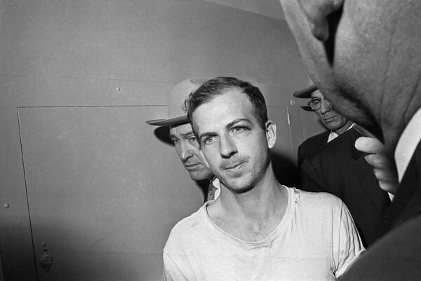 In this Nov. 23, 1963 file photo, Lee Harvey Oswald is led down a corridor of the Dallas police station for another round of questioning in connection with the assassination of US, President John F. Kennedy. Oswald, who denied any involvement in the shooting, was formally charged with murder.  - Sputnik International