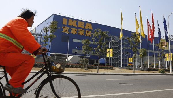 A public worker rides a bicycle in front of an Ikea shop Wednesday March 6, 2013 in Shanghai, China. Chinese authorities say they have destroyed nearly two tons of chocolate cake imported by Sweden's Ikea for violating food quality standards. - Sputnik International