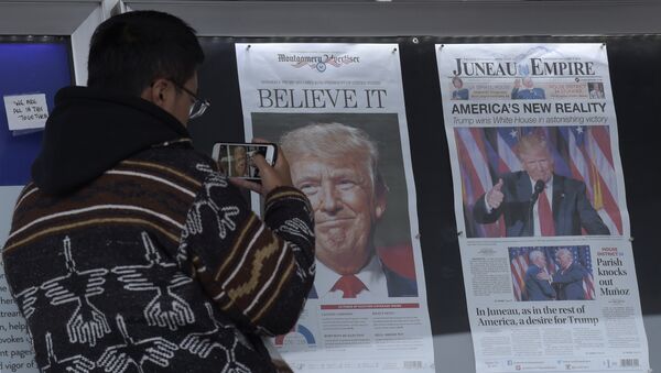 Zheng Gao of Shanghi, China, photographs the front pages of newspapers on display outside the Newseum in Washington, Wednesday, Nov., 9, 2016 - Sputnik International