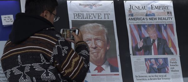 Zheng Gao of Shanghi, China, photographs the front pages of newspapers on display outside the Newseum in Washington, Wednesday, Nov., 9, 2016 Zheng Gao of Shanghi, China, photographs the front pages of newspapers on display outside the Newseum in Washington, Wednesday, Nov., 9, 2016 - Sputnik International