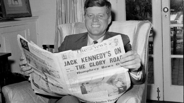 Sen. John F. Kennedy (D-MA) reads the daily newspaper accounts of his West Virginia election victory as he relaxes, May 11, 1960, in his Washington home. Kennedy defeated Sen. Hubert Humphrey (D-MN) in yesterday's presidential primary. - Sputnik International