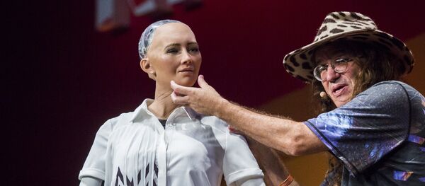 Chief scientist of Hanson Robotics, Ben Goertzel (R), describes to the audience what Sophia the Robot (L) is made of during a discussion about the future of humanity in a demonstration of artificial intelligence (AI) by Hanson Robotics at the RISE Technology Conference in Hong Kong on July 12, 2017 Chief scientist of Hanson Robotics, Ben Goertzel (R), describes to the audience what Sophia the Robot (L) is made of during a discussion about the future of humanity in a demonstration of artificial intelligence (AI) by Hanson Robotics at the RISE Technology Conference in Hong Kong on July 12, 2017 - Sputnik International