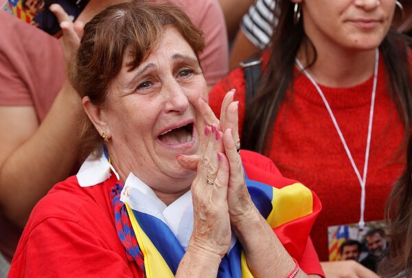 A woman reacts while the Catalan regional parliament votes for independence of Catalonia from Spain in Barcelona A woman reacts while the Catalan regional parliament votes for independence of Catalonia from Spain in Barcelona - Sputnik International