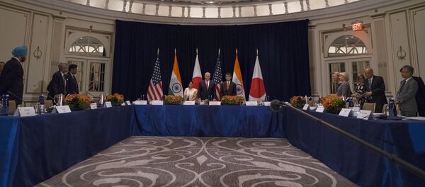 U.S. Secretary of State Rex Tillerson, center at center table, stands with Indian External Affairs Minister Sushma Swaraj, left, and Japanese Foreign Minister Taro Kono, at the Palace Hotel during a meeting in New York, Monday, Sept. 18, 2017 - Sputnik International