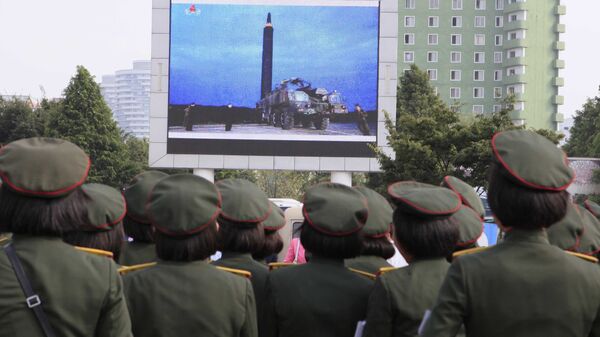 People fill the square of the main railway station to watch a televised news broadcast of the test-fire of an inter-continental ballistic rocket Hwasong-12, Wednesday, August 30, 2017, in Pyongyang, North Korea - Sputnik International