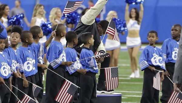 In a file photo from Sept. 24, 2017, National anthem singer Rico Lavelle bends to his knee, bows his head and raises his fist after singing the anthem before the first half of an NFL football game between the Detroit Lions and the Atlanta Falcons in Detroit. The sight of football players kneeling during the national anthem is the continuation of a tradition nearly as old the song itself. University of Michigan musicology professor Mark Clague says The Star-Spangled Banner has been a channel for protest since at least the 1840s. The lyrics were recast as an anti-slavery song and it's been used or reworked to push for racial equality, women's suffrage, prohibition and labor rights. - Sputnik International