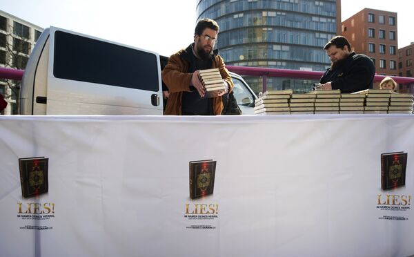 Supporters of the Salafist group House of the Quran (Haus vom Karan) give out Korans at Potsdamer Plarz in Berlin on April 14, 2012. The banner reads: Read! in the name of your Lord Supporters of the Salafist group House of the Quran (Haus vom Karan) give out Korans at Potsdamer Plarz in Berlin on April 14, 2012. The banner reads: Read! in the name of your Lord - Sputnik International