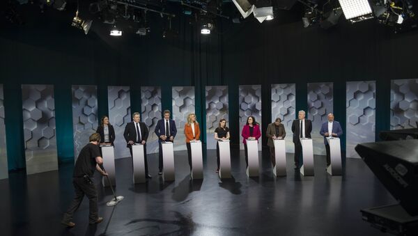 A worker cleans a floor as Iceland's political parties politicians attend a television debate in Reykjavik, Iceland October 27, 2017 - Sputnik International