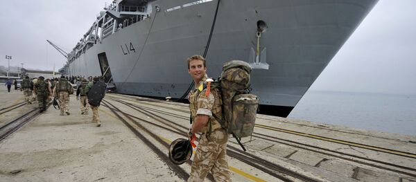 A British soldier looks back while walking to the HMS Albion warship of the British Royal Navy at anchor at port of Santander northern Spain, Tuesday, April 20, 2010. - Sputnik International