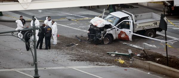 Authorities stand near a damaged Home Depot truck after a motorist drove onto a bike path near the World Trade Center memorial, striking and killing several people Tuesday, Oct. 31, 2017, in New York - Sputnik International