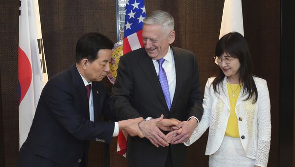 (File) U.S. Defense Secretary Jim Mattis, center, shakes hands with South Korea's Minister of Defense Han Minkoo, left, and Japan's Minister of Defense Tomomi Inada, right, ahead of a trilateral meeting at the 2017 International Institute for Strategic Studies (IISS) Shangri-la Dialogue, an annual defense and security forum in Asia, on Saturday, June 3, 2017 in Singapore - Sputnik International