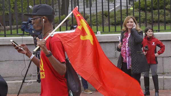 Taizjan Wallace, from the Roxbery section of Boston, carries a Soviet Union hammer & sickle flag in front of the Statehouse after a M1 Coalition Here to Stay May Day Immigration rally which he did not participate in Monday, May 1, 2017, in Boston - Sputnik International