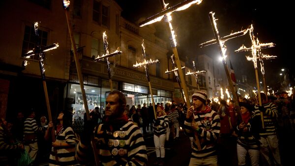 Participants in costumes hold burning crosses as they take part in one of a series of processions during Bonfire Night celebrations in Lewes, Britain November 4, 2017 - Sputnik International