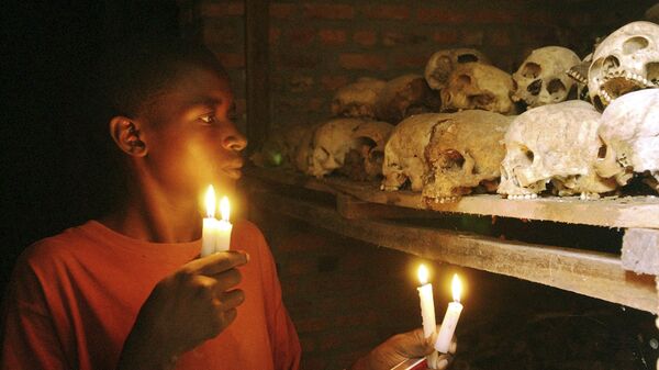 FILE - In this April 6, 2004 file photo, Apollan Odetta, a survivor from the 1994 Rwandan Genocide light candles at a mass grave in Nyamata, Rwanda - Sputnik International