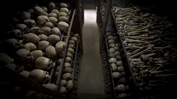 The skulls and bones of some of those who were slaughtered as they sought refuge inside the church, are laid out on shelves in an underground vault as a memorial to the thousands who were killed in and around the Catholic church during the 1994 genocide in Nyamata, Rwanda, Friday, April 4, 2014 - Sputnik International