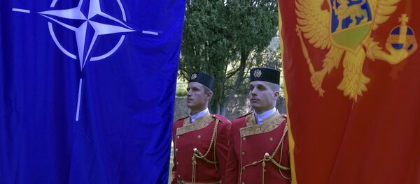 Montenegrin guards of honor stand between NATO, left, and Montenegro flags during ceremony to mark Montenegro's accession to NATO, in Podgorica, Montenegro, Wednesday, June 7, 2017 - Sputnik International