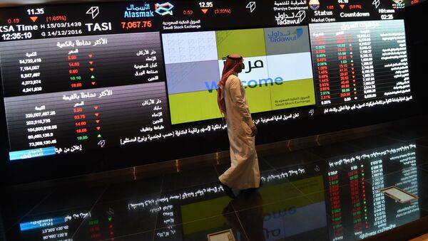 Saudi investor walking past the stock exchange monitors at the Saudi Stock Exchange, or Tadawul, in the capital Riyadh (File) - Sputnik International