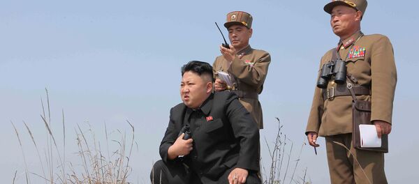 North Korean leader Kim Jong Un (C) guides the multiple-rocket launching drill of women's sub-units under KPA Unit 851, in this undated photo released by North Korea's Korean Central News Agency (KCNA) April 24, 2014 - Sputnik International