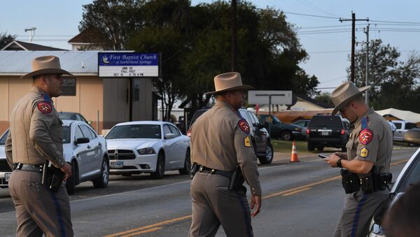 State troopers patrol at the entrance to the First Baptist Church (back) after a mass shooting that killed 26 people in Sutherland Springs, Texas on November 6, 2017 - Sputnik International