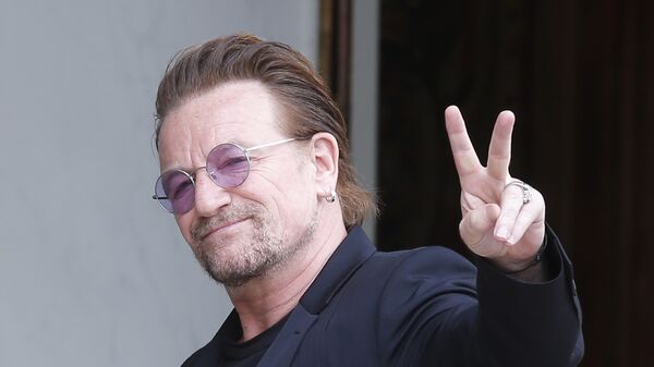 In this Monday, July 24, 2017 file photo, U2 singer Bono makes a peace sign as he arrives for a meeting at the Elysee Palace, in Paris, France. - Sputnik International
