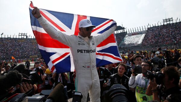 Mercedes' Lewis Hamilton celebrates after winning the World Championship - Sputnik International