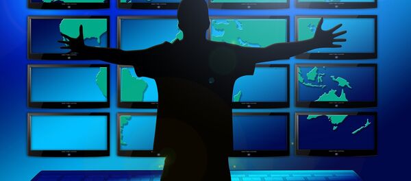 A silhouette of a man in front of multiple screens - Sputnik International