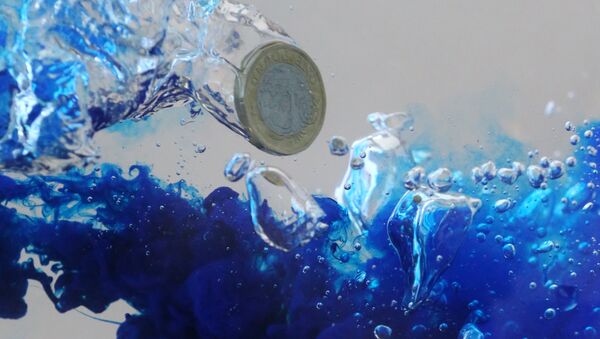 UK pound coin plunges into water in this illustration picture, October 26, 2017. Picture taken October 26, 2017. - Sputnik International