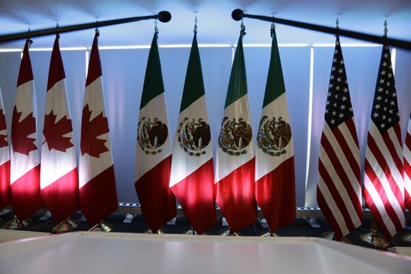 National flags representing Canada, Mexico, and the US are lit by stage lights at the North American Free Trade Agreement, NAFTA, renegotiations, in Mexico City, Tuesday, Sept. 5, 2017. National flags representing Canada, Mexico, and the US are lit by stage lights at the North American Free Trade Agreement, NAFTA, renegotiations, in Mexico City, Tuesday, Sept. 5, 2017. - Sputnik International