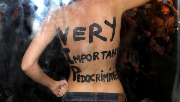 A feminist protester from the Femen group reveals messages written on her body upon the arrival of director Roman Polanski at an event organised by Cinematheque Francaise in Paris, France, October 30, 2017. - Sputnik International
