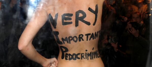 A feminist protester from the Femen group reveals messages written on her body upon the arrival of director Roman Polanski at an event organised by Cinematheque Francaise in Paris, France, October 30, 2017. A feminist protester from the Femen group reveals messages written on her body upon the arrival of director Roman Polanski at an event organised by Cinematheque Francaise in Paris, France, October 30, 2017. - Sputnik International