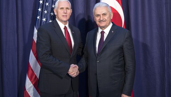 United States Vice President Mike Pence, left and Turkey's Prime Minister Binali Yildirim, right, shake hands for the photographers prior to their meeting during the Munich Security Conference in Munich, Germany - Sputnik International
