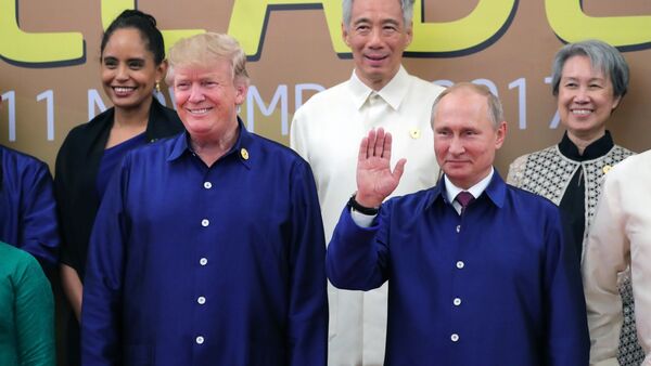 Russian President Vladimir Putin and US President Donald Trump, left, front, taking part in the traditional ceremony of taking photos in national Vietnamese clothes during APEC Economic Leaders’ Meeting in Vietnam - Sputnik International