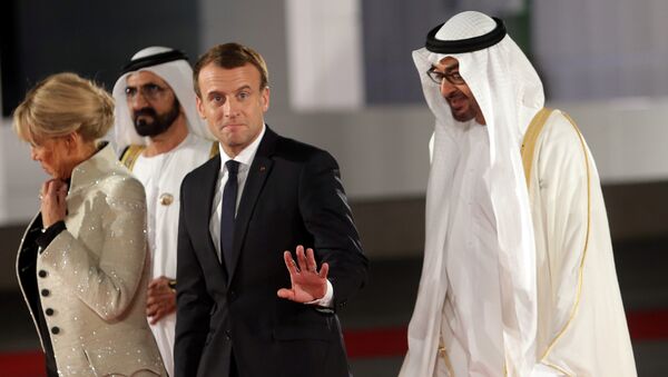 French President Emmanuel Macron gestures as he is welcomed by Abu Dhabi Crown Prince Sheikh Mohammed bin Zayed al-Nahyan and Prime Minister and Vice-President of UAE and Ruler of Dubai Sheikh Mohammed bin Rashid al-Maktoum upon Macron's arrival with his wife at the Louvre Abu Dhabi, in Abu Dhabi, UAE, November 8, 2017 - Sputnik International
