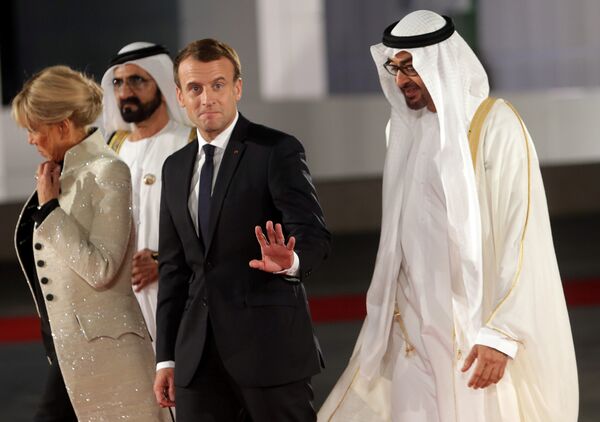 French President Emmanuel Macron gestures as he is welcomed by Abu Dhabi Crown Prince Sheikh Mohammed bin Zayed al-Nahyan and Prime Minister and Vice-President of UAE and Ruler of Dubai Sheikh Mohammed bin Rashid al-Maktoum upon Macron's arrival with his wife at the Louvre Abu Dhabi, in Abu Dhabi, UAE, November 8, 2017 - Sputnik International