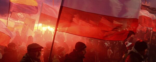 Demonstrators burn flares and wave Polish flags during the annual march to commemorate Poland's National Independence Day in Warsaw, Saturday, Nov. 11, 2017. Thousands of nationalists marched in Warsaw on Poland's Independence Day holiday, taking part in an event that was organized by far-right groups - Sputnik International