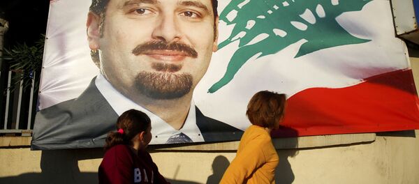 A woman and her daughter pass by a poster of outgoing Prime Minister Saad Hariri, in Beirut, Lebanon, Saturday, Nov. 11, 2017. Lebanon's president has called on Saudi Arabia to clarify the reasons why the country's prime minister has not returned home since his resignation which was announced from the kingdom A woman and her daughter pass by a poster of outgoing Prime Minister Saad Hariri, in Beirut, Lebanon, Saturday, Nov. 11, 2017. Lebanon's president has called on Saudi Arabia to clarify the reasons why the country's prime minister has not returned home since his resignation which was announced from the kingdom - Sputnik International