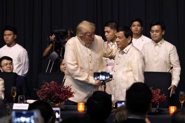 U.S. President Donald Trump shakes hands with Philippines President Rodrigo Duterte during the gala dinner marking ASEAN's 50th anniversary in Manila, Philippines November 12, 2017 U.S. President Donald Trump shakes hands with Philippines President Rodrigo Duterte during the gala dinner marking ASEAN's 50th anniversary in Manila, Philippines November 12, 2017 - Sputnik International