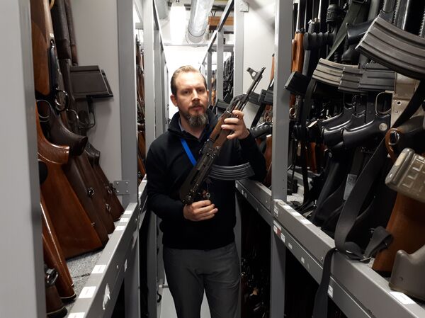 A member of the forensic firearms unit shows off one of the 7,500 guns they have stored A member of the forensic firearms unit shows off one of the 7,500 guns they have stored - Sputnik International