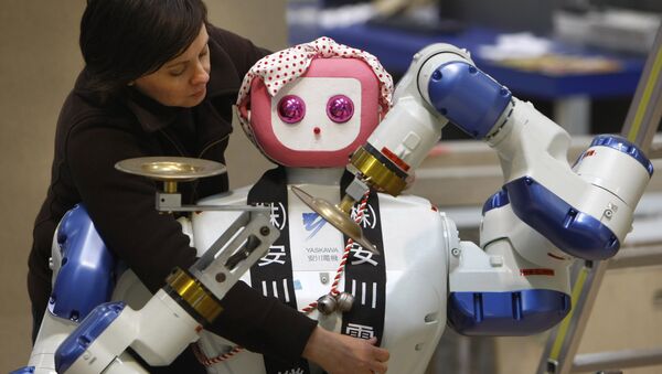 Annette Vorreiter decorates a dual arm robot maid by Japan's Yaskawa Electric company during preparation of the Hanover industrial fair in Hanover, Germany, Friday, April 18, 2008 - Sputnik International