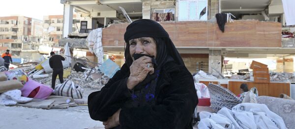 An earthquake survivor weeps as she sits in front of damaged buildings, in a compound which was built under the Mehr state-owned program, in Sarpol-e-Zahab in western Iran, Tuesday, Nov. 14, 2017 An earthquake survivor weeps as she sits in front of damaged buildings, in a compound which was built under the Mehr state-owned program, in Sarpol-e-Zahab in western Iran, Tuesday, Nov. 14, 2017 - Sputnik International