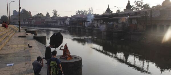 A Hindu holy man poses for a photographer on the bank of the Bagmati River near the Pashupatinath Hindu temple in Katmandu, Nepal. (File) A Hindu holy man poses for a photographer on the bank of the Bagmati River near the Pashupatinath Hindu temple in Katmandu, Nepal. (File) - Sputnik International