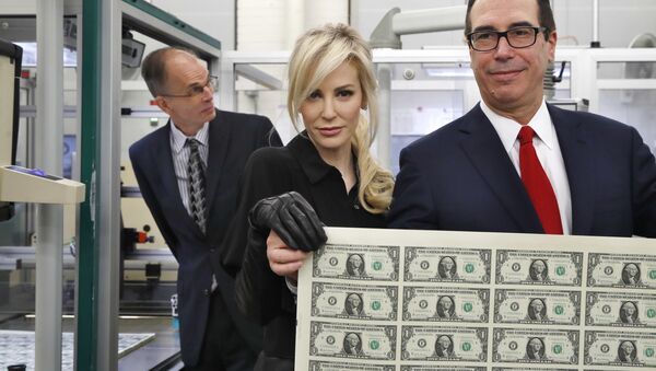 Treasury Secretary Steven Mnuchin, right, and his wife Louise Linton, hold up a sheet of new $1 bills, the first currency notes bearing his and U.S. Treasurer Jovita Carranza's signatures, Wednesday, Nov. 15, 2017, at the Bureau of Engraving and Printing (BEP) in Washington. - Sputnik International