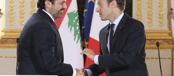 In this Sept. 1 2017 file photo, French President Emmanuel Macron, right, shakes hands with Lebanese Prime Minister Saad Hariri during a joint press conference at the Elysee Palace in Paris. - Sputnik International