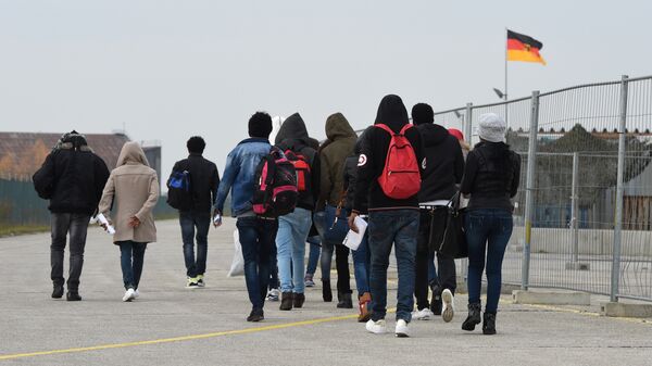 Migrants arrive at the first registration point for asylum seekers in Erding near Munich, southern Germany, on November 15, 2016 - Sputnik International