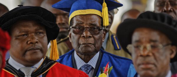 Zimbabwe's President Robert Mugabe, center, arrives to preside over a student graduation ceremony at Zimbabwe Open University on the outskirts of Harare, Zimbabwe Friday, Nov. 17, 2017 Zimbabwe's President Robert Mugabe, center, arrives to preside over a student graduation ceremony at Zimbabwe Open University on the outskirts of Harare, Zimbabwe Friday, Nov. 17, 2017 - Sputnik International