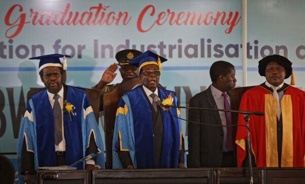 Zimbabwe's President Robert Mugabe, center, stands for the national anthem after arriving to preside over a student graduation ceremony at Zimbabwe Open University on the outskirts of Harare, Zimbabwe Friday, Nov. 17, 2017 Zimbabwe's President Robert Mugabe, center, stands for the national anthem after arriving to preside over a student graduation ceremony at Zimbabwe Open University on the outskirts of Harare, Zimbabwe Friday, Nov. 17, 2017 - Sputnik International