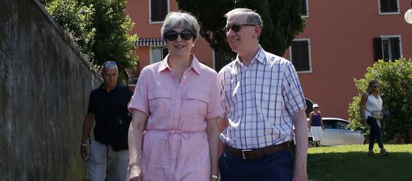 Britain Prime Minister Theresa May, left, walks with her husband Philip as they visit Desenzano del Garda, by the Garda lake, northern Italy, Tuesday, July 25, 2017. May is spending her holidays in northern Italy. - Sputnik International