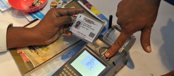 An Indian visitor gives a thumb impression to withdraw money from his bank account with his Aadhaar or Unique Identification (UID) card during a Digi Dhan Mela, held to promote digital payment, in Hyderabad on January 18, 2017 An Indian visitor gives a thumb impression to withdraw money from his bank account with his Aadhaar or Unique Identification (UID) card during a Digi Dhan Mela, held to promote digital payment, in Hyderabad on January 18, 2017 - Sputnik International