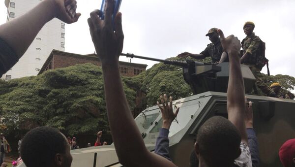 People begin to gather around a military vehicle in Harare Saturday, Nov. 18, 2017, demonstrating for the ouster of 93-year-old president Robert Mugabe who is virtually powerless and deserted by most of his allies - Sputnik International