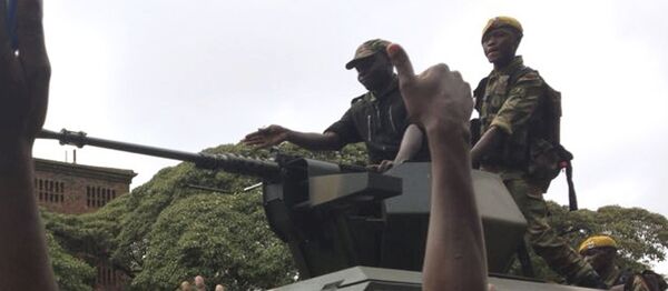 People begin to gather around a military vehicle in Harare Saturday, Nov. 18, 2017, demonstrating for the ouster of 93-year-old president Robert Mugabe who is virtually powerless and deserted by most of his allies People begin to gather around a military vehicle in Harare Saturday, Nov. 18, 2017, demonstrating for the ouster of 93-year-old president Robert Mugabe who is virtually powerless and deserted by most of his allies - Sputnik International